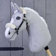 Grey Hobby Horse wearing the black leatherette halter with cream fur on the noseband and behind the ears