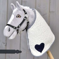 Light grey Hobby Horse in a black halter wearing the Blanket cube blue with navy heart and checked trim