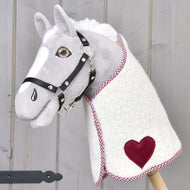 Light grey Hobby Horse in a black halter wearing the Blanket cube red with burgundy heart and checked trim