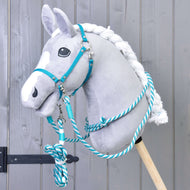 Grey plush Hobby Horse in the turquoise halter with the turquoise and white rope cordeo and coiled lead rope