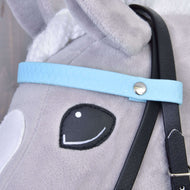 Close-up of the light blue honeycomb browband with silver rivet and black cheekpiece on a grey Hobby Horse