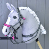 Grey Hobby Horse with braided white mane wearing the grey rope halter with pink noseband and grey rope reins