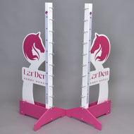 Both stands at an angle: white wings with the pink horse head and girl logo, LarDen lettering and pink cross feet