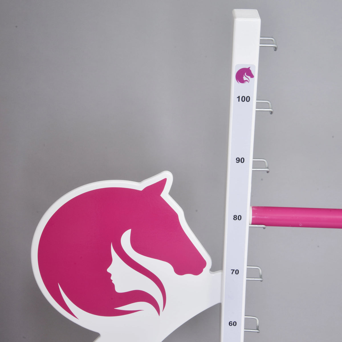 Närbild av det rosa hästhuvudet och flicksiluetten på en vinge bredvid skalan, med en rosa bom som vilar vid 80 cm