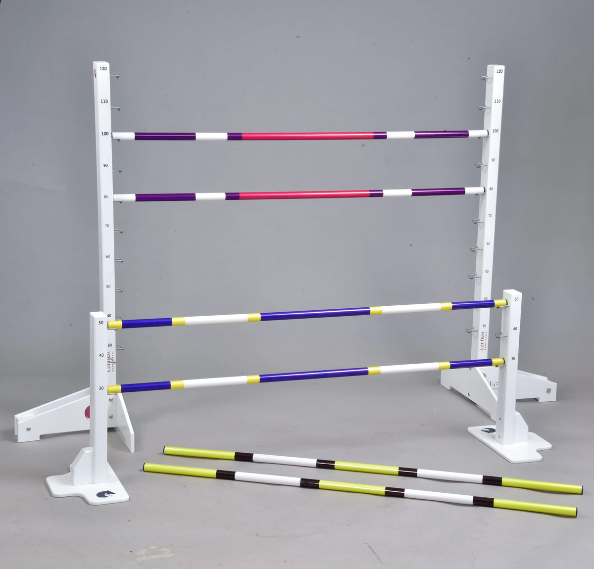 Angled view of the full set: purple-pink poles on the tall stands, blue-yellow on the low ones and two on the floor