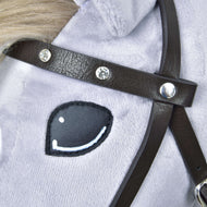 Close-up of the dark brown leatherette browband set with sparkling rhinestones, above the eye of a light grey Hobby Horse