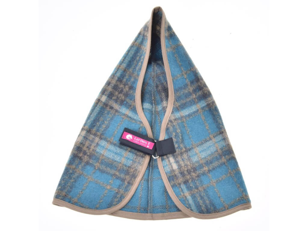 Blue and beige tartan stable blanket laid open from the front, taupe binding and the black strap closure in the middle