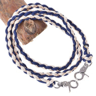 Hobby Horse Reins Cremo/Blue by LarDen, braided navy blue and cream cord with two silver snap hooks, on a branch