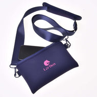 Hobby Horse Cross body bag by LarDen in navy neoprene with a pink horse head logo, wide strap and a phone peeking out