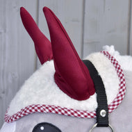 Burgundy ears and red checked edge of the white sherpa ear bonnet on a grey Hobby Horse, black halter strap in view