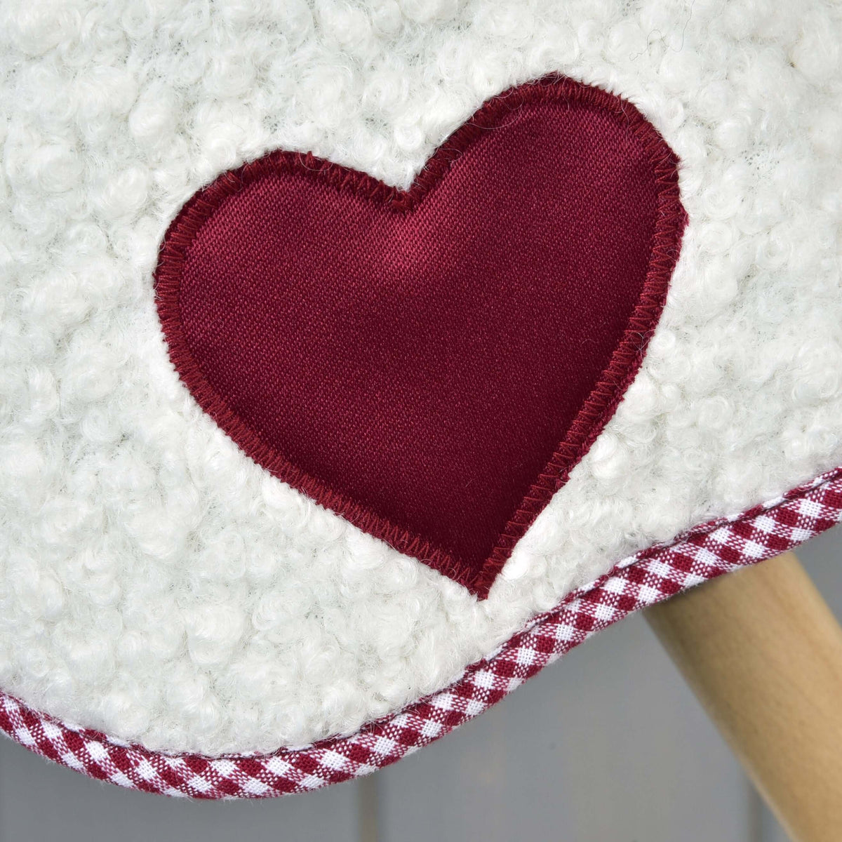 Close-up of the burgundy heart patch with zigzag stitching on the Hobby Horse Blanket cube red