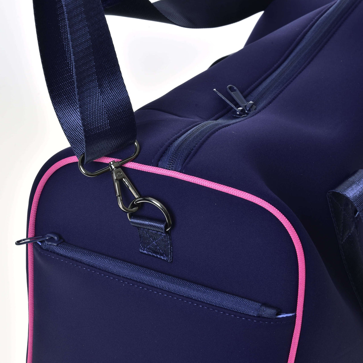 Close-up of the shoulder strap's snap hook clipped to the D-ring on the pink-piped end of the Hobby Horse Sports bag