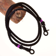Hobby Horse Reins Violette by LarDen, black braided rope reins with purple wraps and black snap hooks over a branch