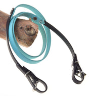 Hobby Horse Reins rubberized turquoise by LarDen with honeycomb texture, black ends and buckles, draped over a branch