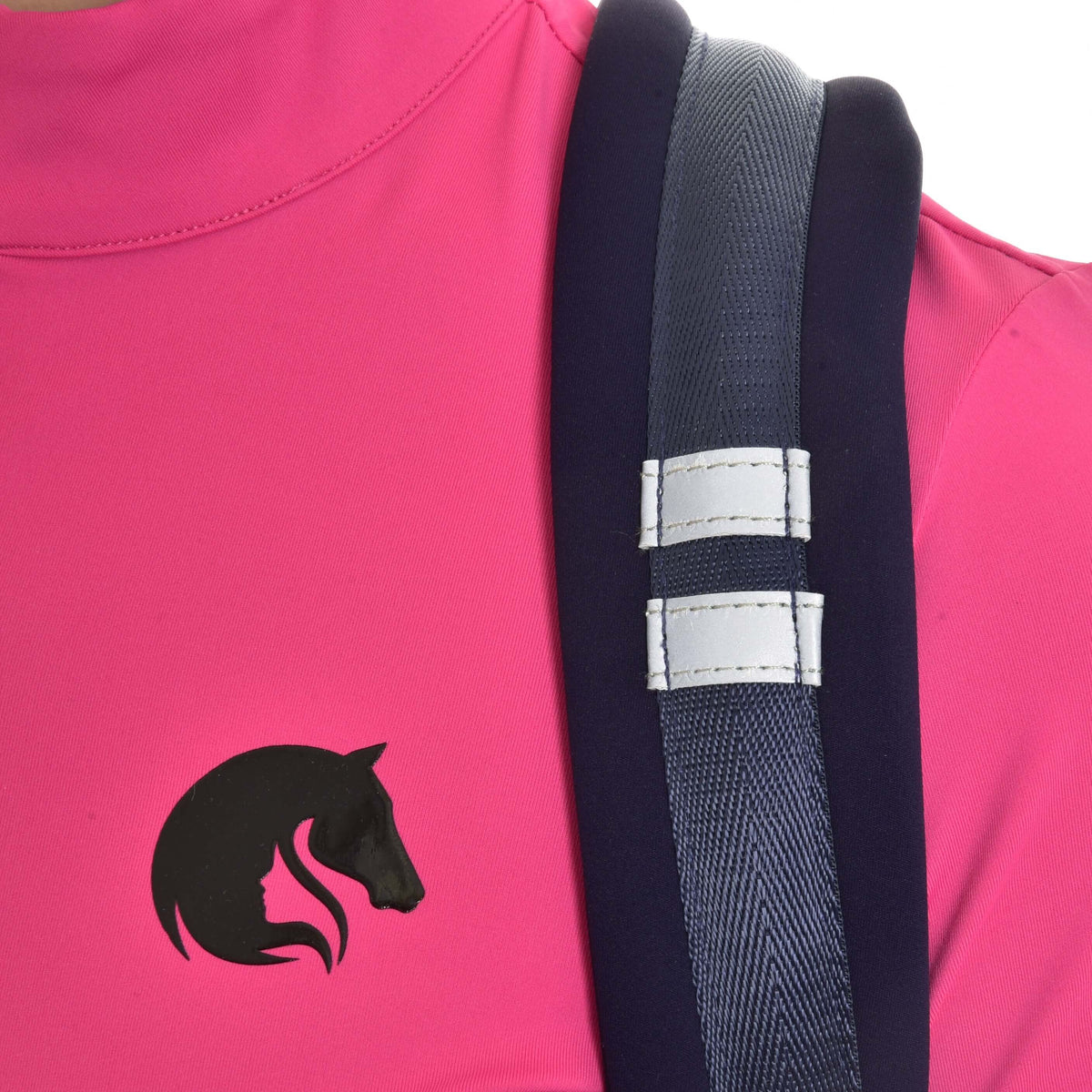 Close-up of a padded Hobby Horse Backpack strap with two reflective strips over a pink shirt with black horse logo