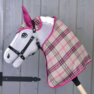 Grey Hobby Horse in a black halter wearing the beige and pink checked blanket and ear bonnet with pink ears
