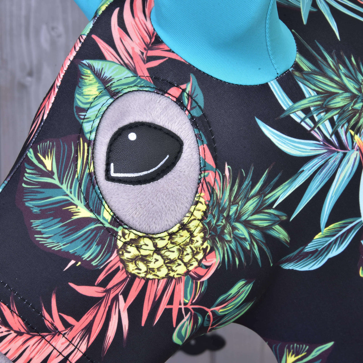 Close-up of the eye opening above a yellow pineapple on the black Pineapple protective suit worn by a Hobby Horse