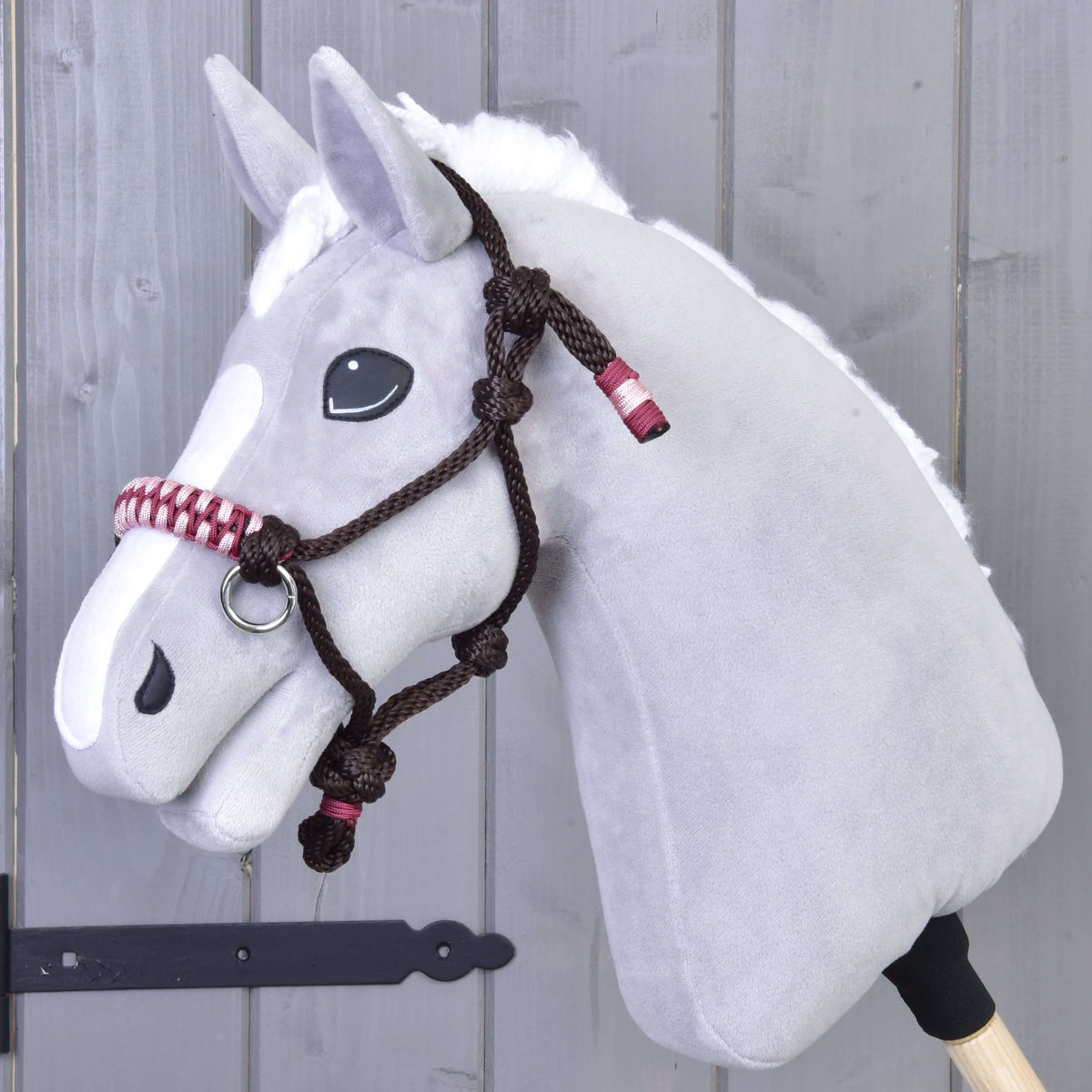 Grey plush Hobby Horse wearing the dark brown York rope halter with pink and burgundy braided noseband
