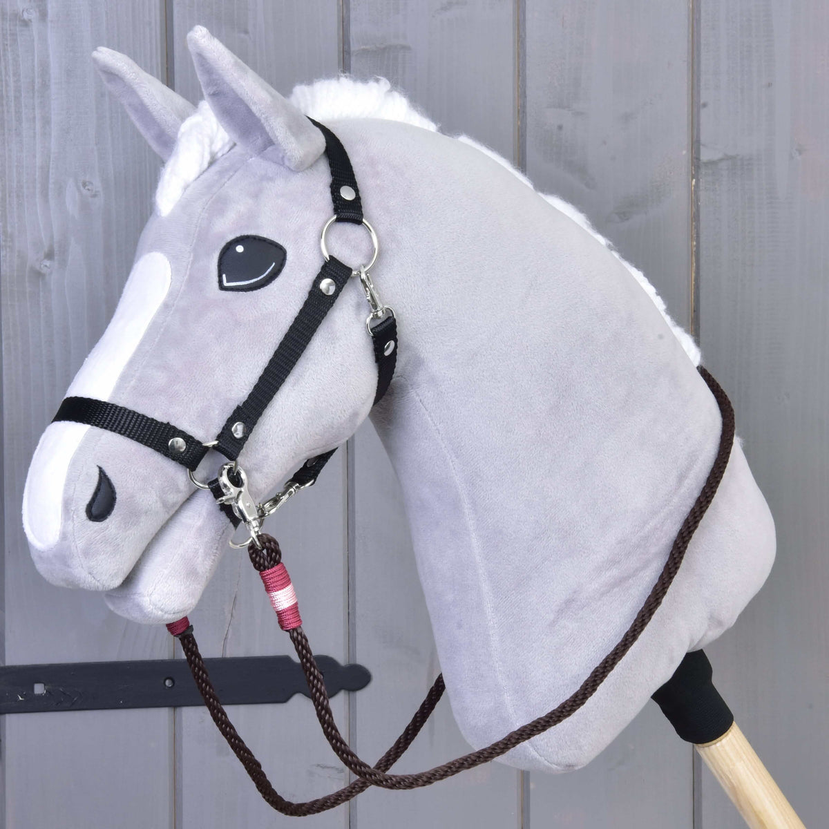 Grey plush Hobby Horse with a black halter and dark brown York rope reins with pink and burgundy wraps