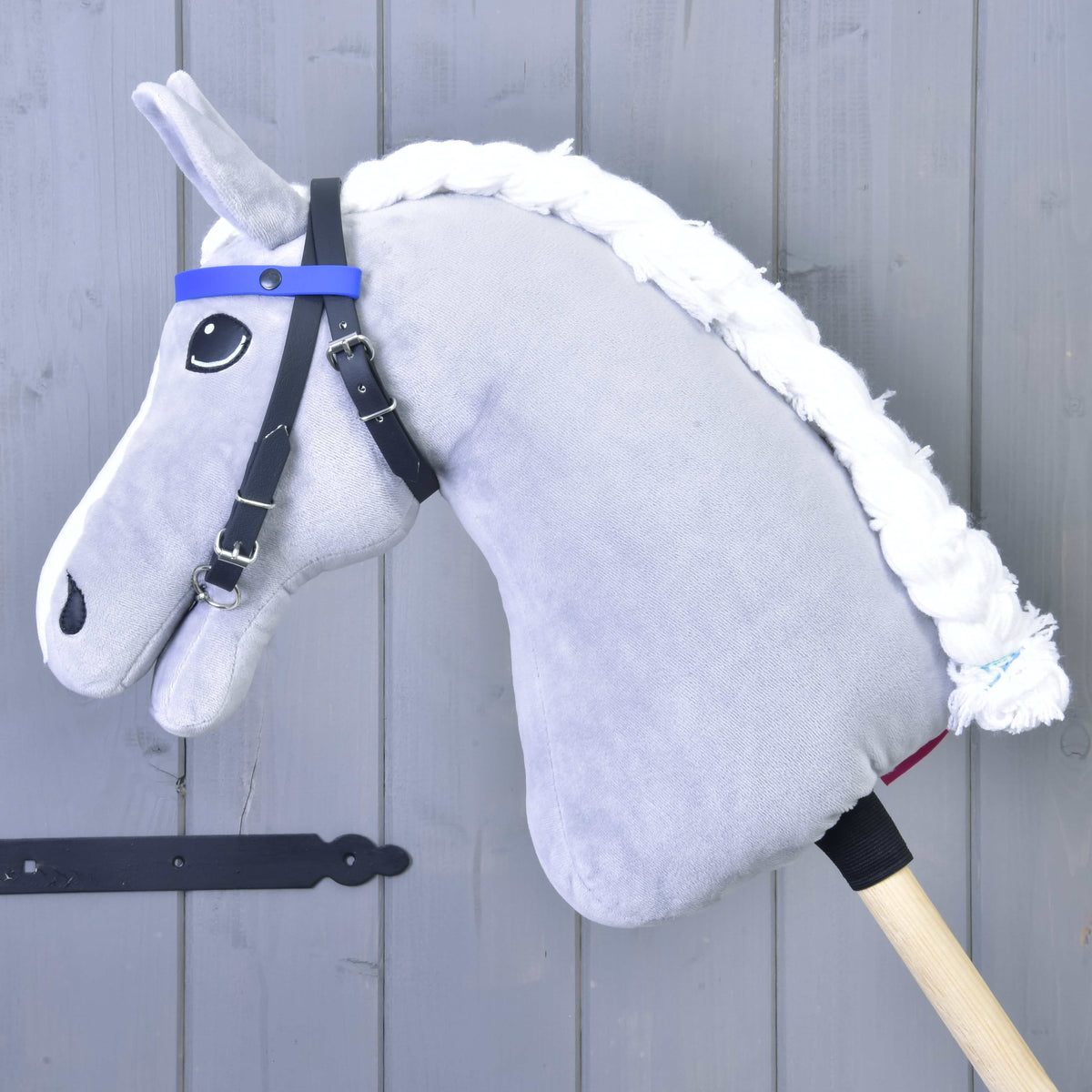LarDen Bridle with 2 Headbands Blue on a grey plush Hobby Horse, black straps with a plain blue browband