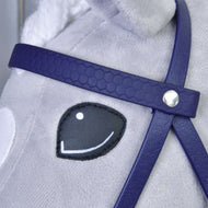 Close-up of the dark purple honeycomb browband with silver rivet beside the smiling eye of a grey Hobby Horse