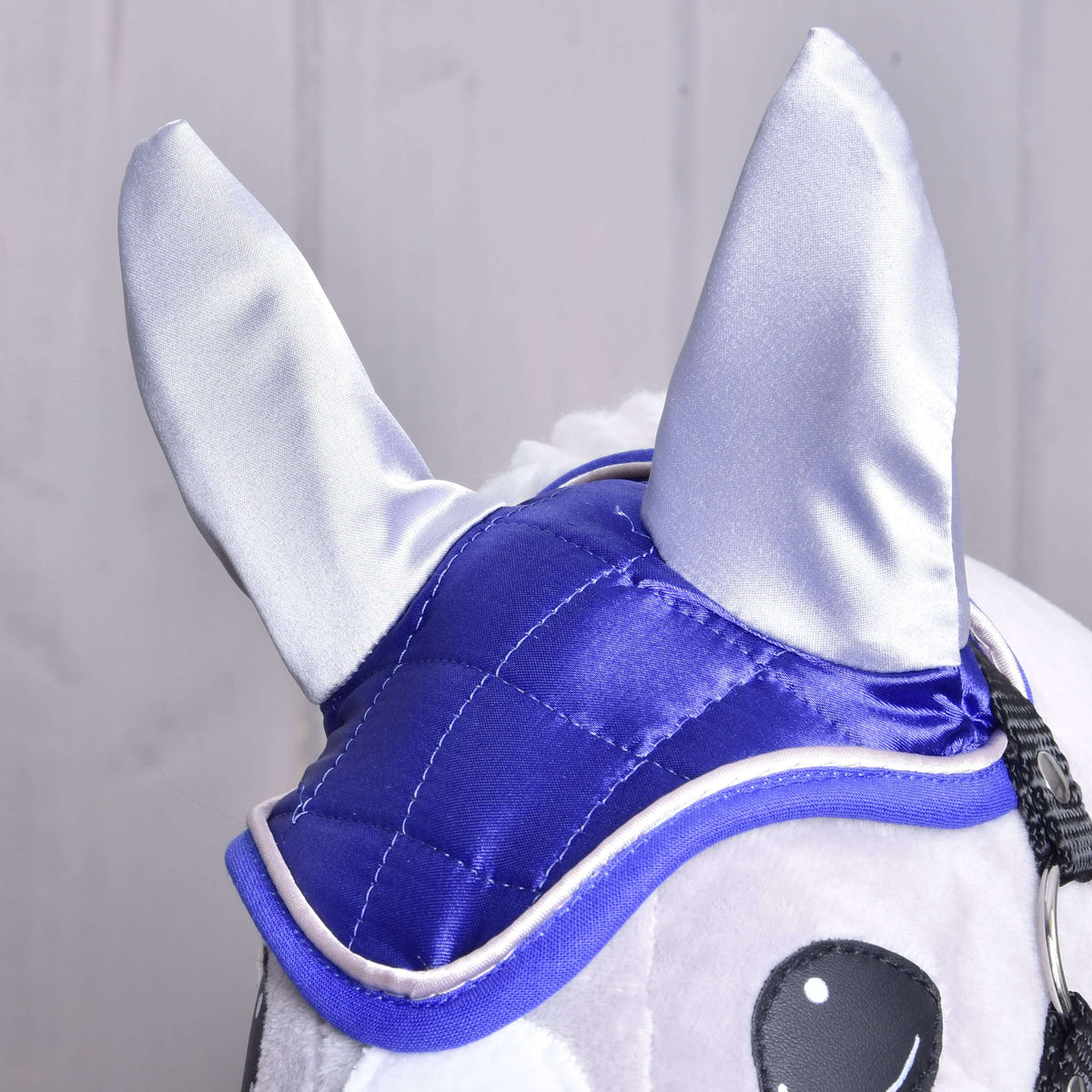 Close-up of the shiny silver grey ears and square-quilted royal blue satin of the DeLuxe Blue ear bonnet