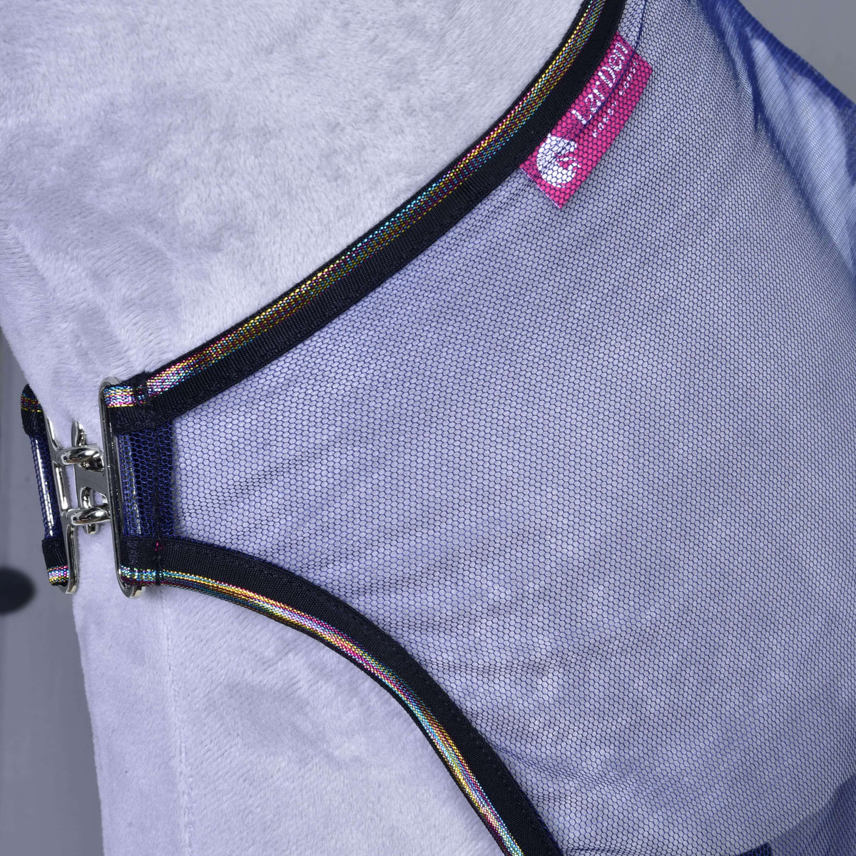 Close-up of the mesh fly sheet on a grey neck: black binding with rainbow piping, the silver clip and a pink LarDen label
