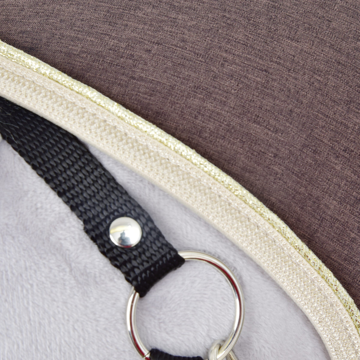 Close-up of the beige and gold trim on the Stable Blanket Brown Majesty beside the black halter ring of a grey Hobby Horse