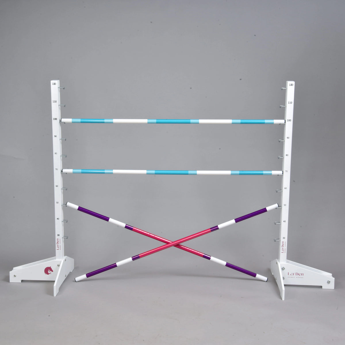 Jump set up as a cross with two purple and pink poles under two turquoise and white poles between white wings