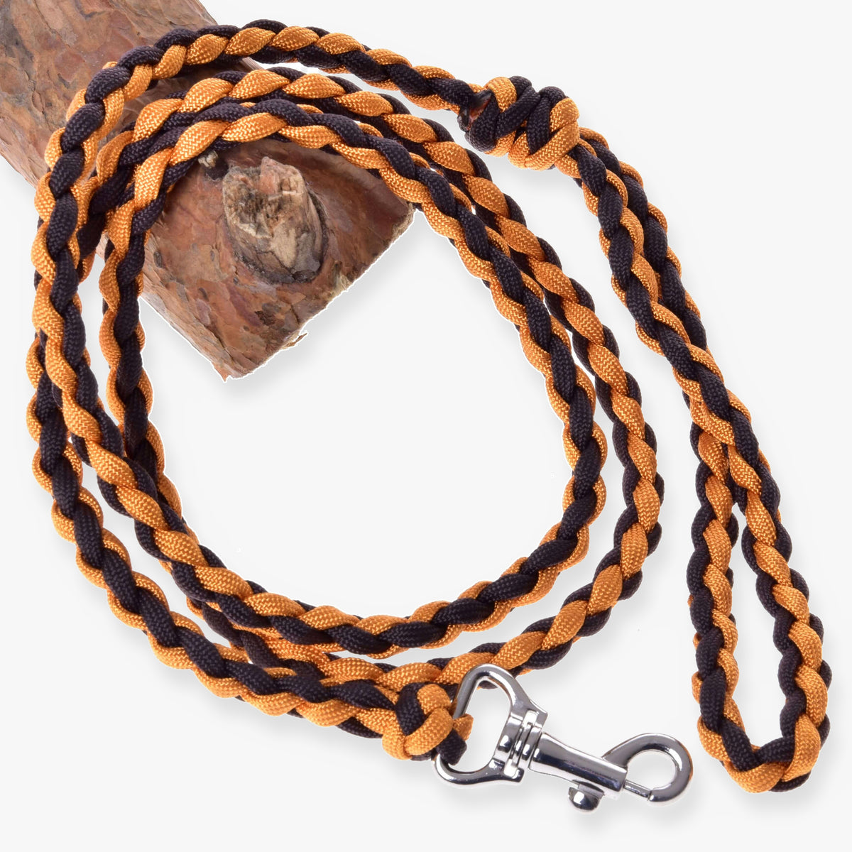 LarDen Hobby Horse Knitted Lead Rope Pomello, orange and black braided paracord lead with silver snap hook on a branch