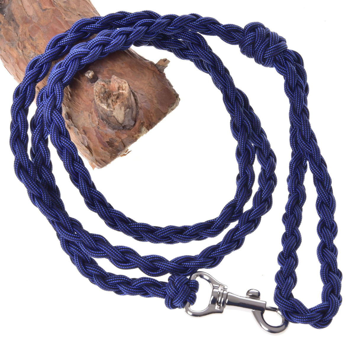 LarDen Hobby Horse Knitted Lead Rope Royal Blue, a braided paracord lead with silver snap hook coiled beside a log