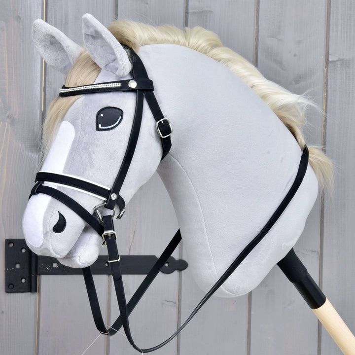 Hobby Horse Complete De Luxe bridle with 2 browbands by LarDen on a grey plush head, with rhinestone browband and reins