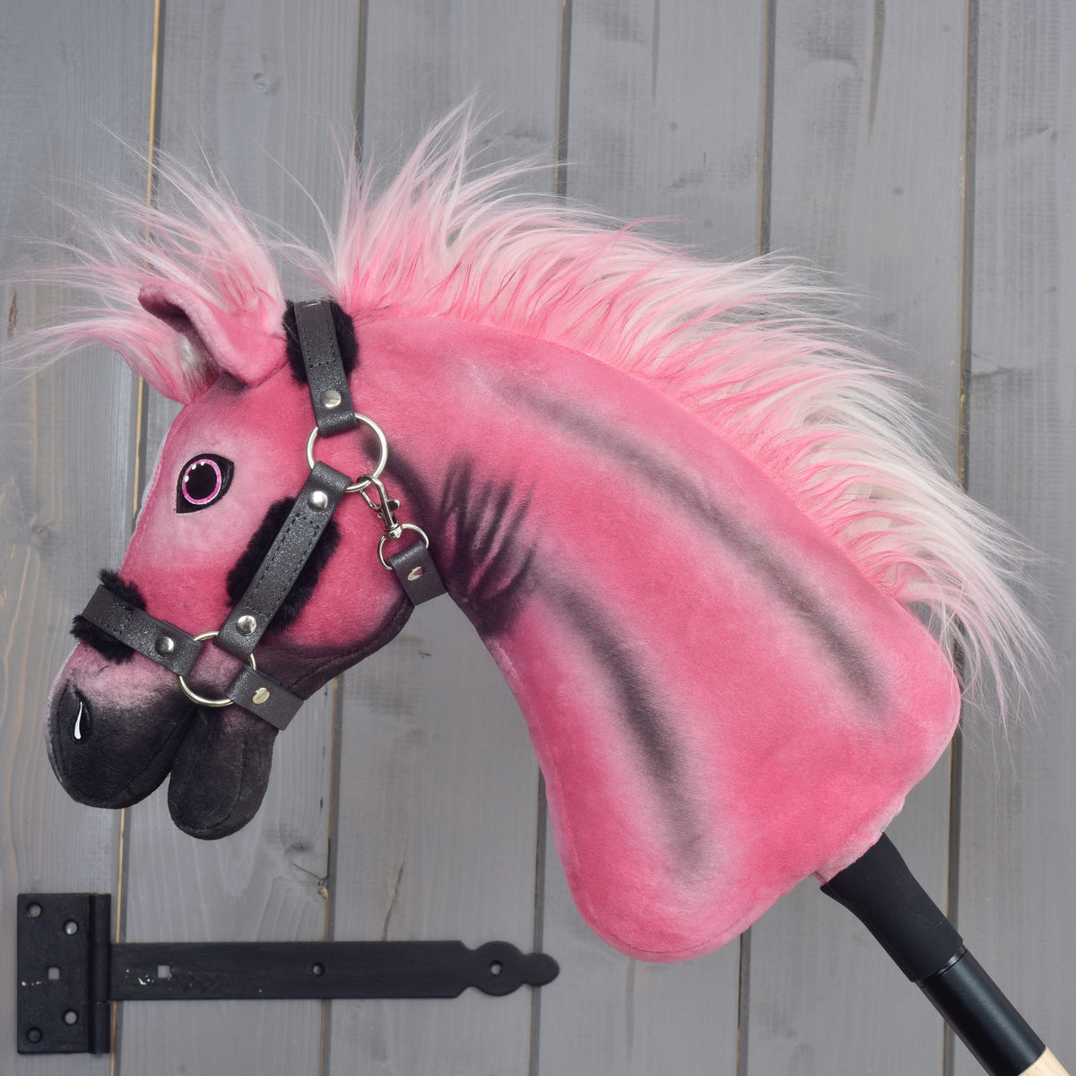 Hobby Horse Pinkie with a glittery halter in left profile, pink and white faux fur mane and black airbrushed neck stripes