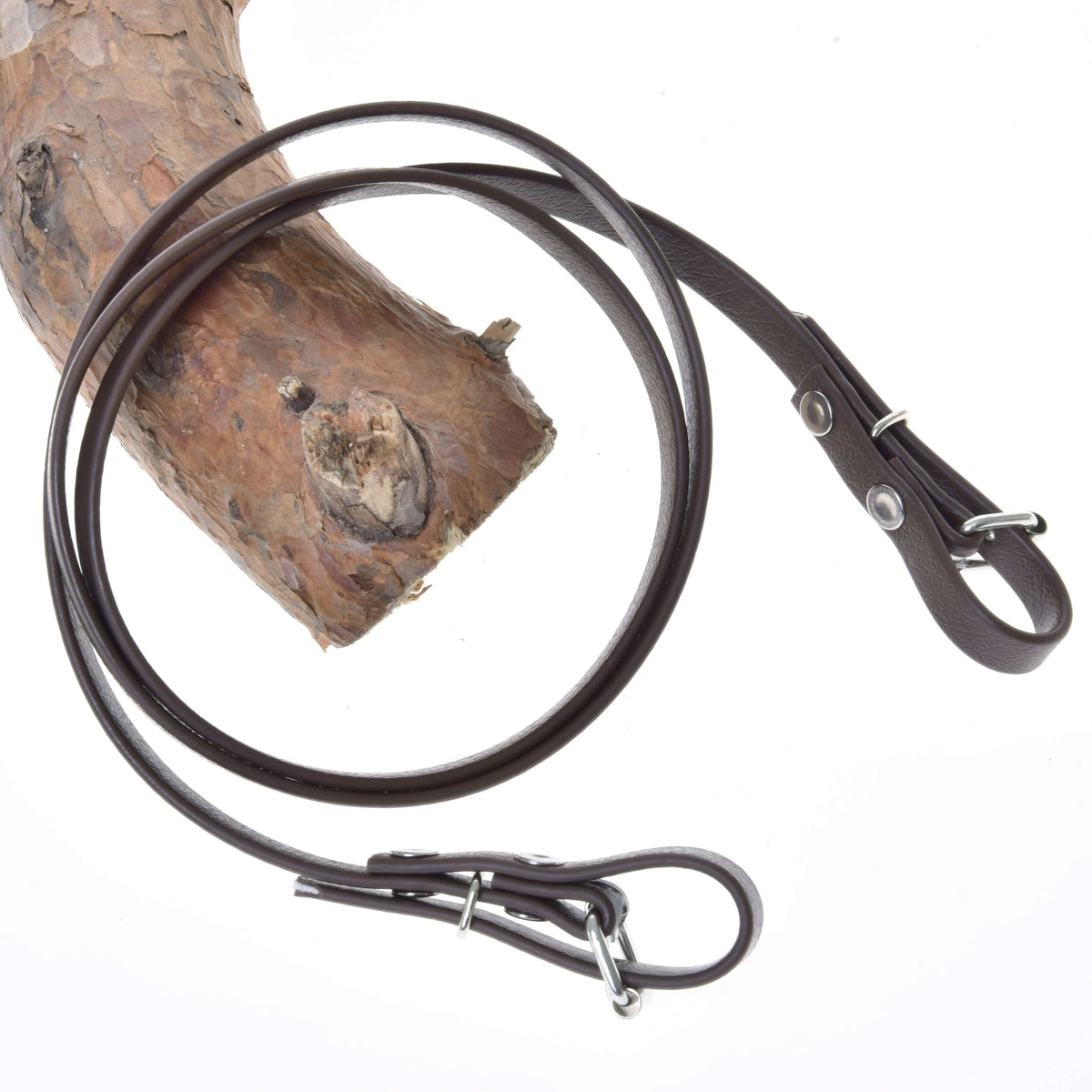 Hobby Horse Reins Light brown by LarDen, smooth brown rubberized reins with buckle ends, looped over a pine branch