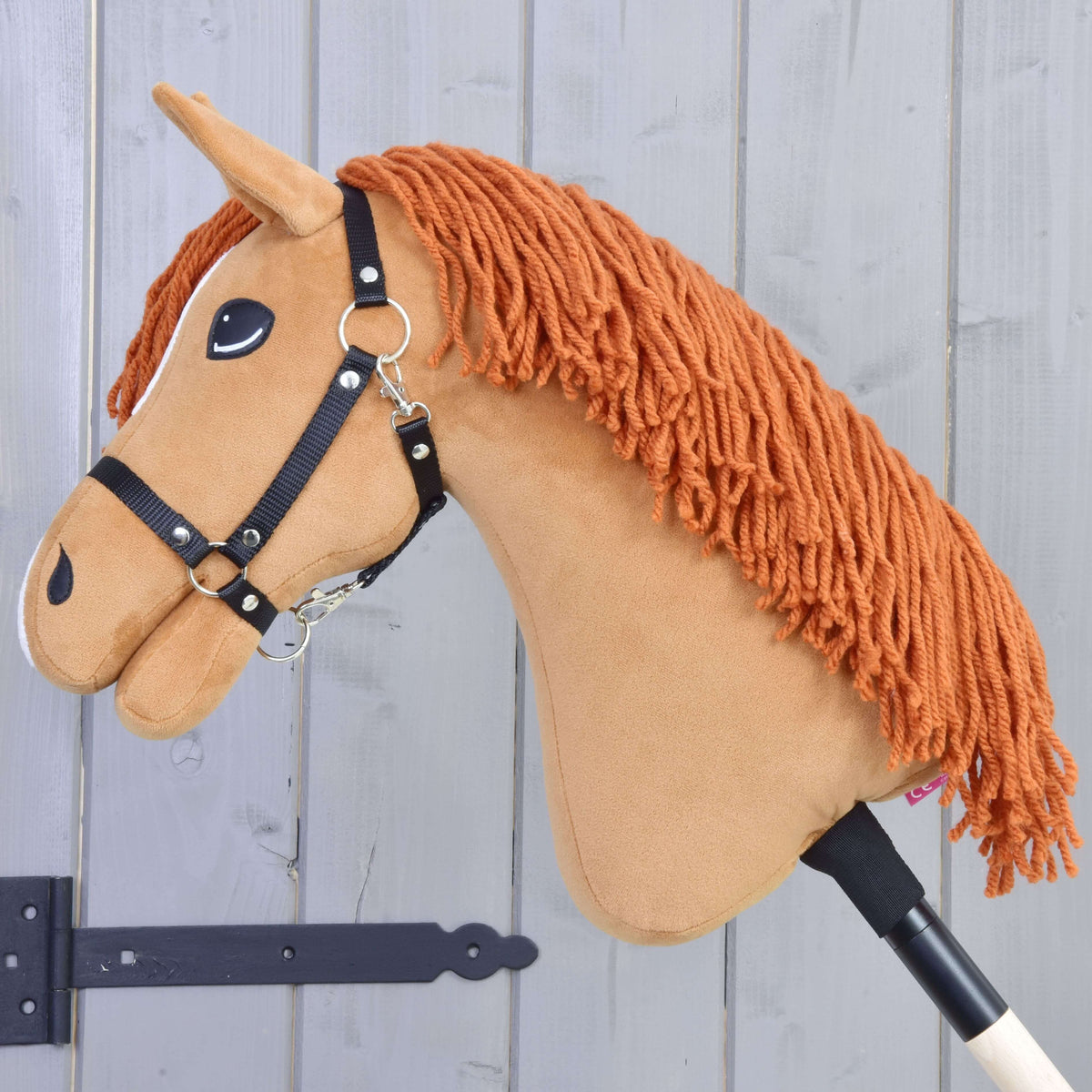 Hobby Horse Little Angel in left profile, the long copper yarn mane falling over the chestnut neck