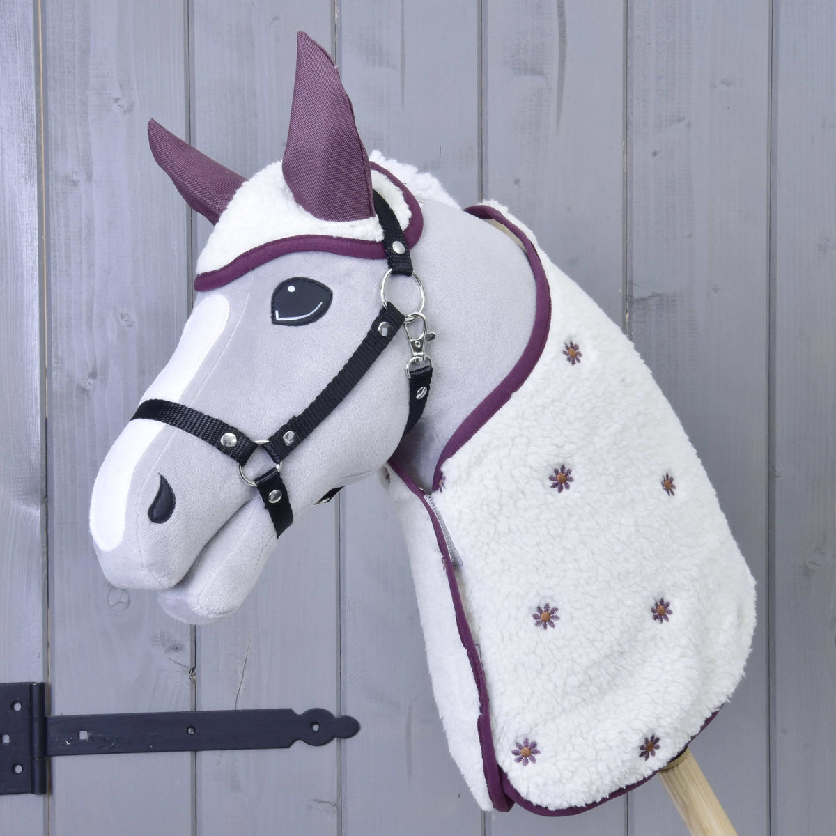 Grey plush Hobby Horse with a black halter wearing the cream sherpa Set Loret with plum ears and embroidered flowers
