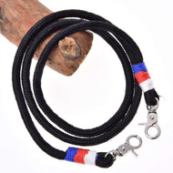 Hobby Horse Reins Emblem CZ by LarDen: black rope reins with white, red and blue wraps and silver snap hooks on a branch