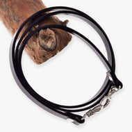 LarDen Hobby Horse Reins Black leatherette coiled over a wooden branch, with silver snap hooks at both ends, on white