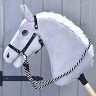 Grey Hobby Horse with a white braided mane wearing a black halter with the Reins black stripe clipped on
