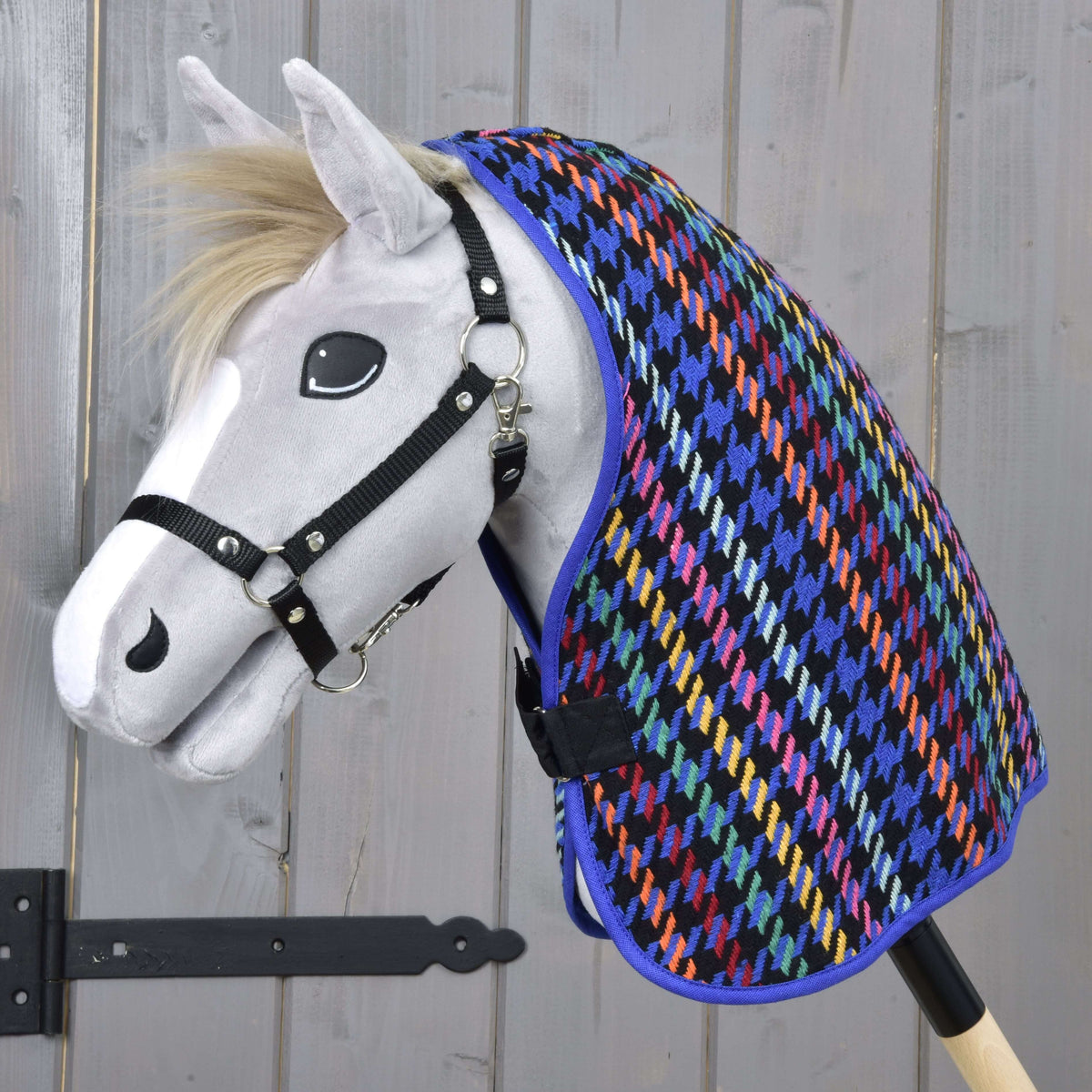 Grey Hobby Horse with a blond mane and black halter wearing the bright houndstooth Stable Blanket Peru over its neck