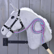 Grey Hobby Horse in a black halter with the pink and turquoise braided lead rope coiled over its neck