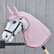 Light grey Hobby Horse in a black halter wearing the Raincoat Veloria in dusty pink with hood, ears and glitter trim