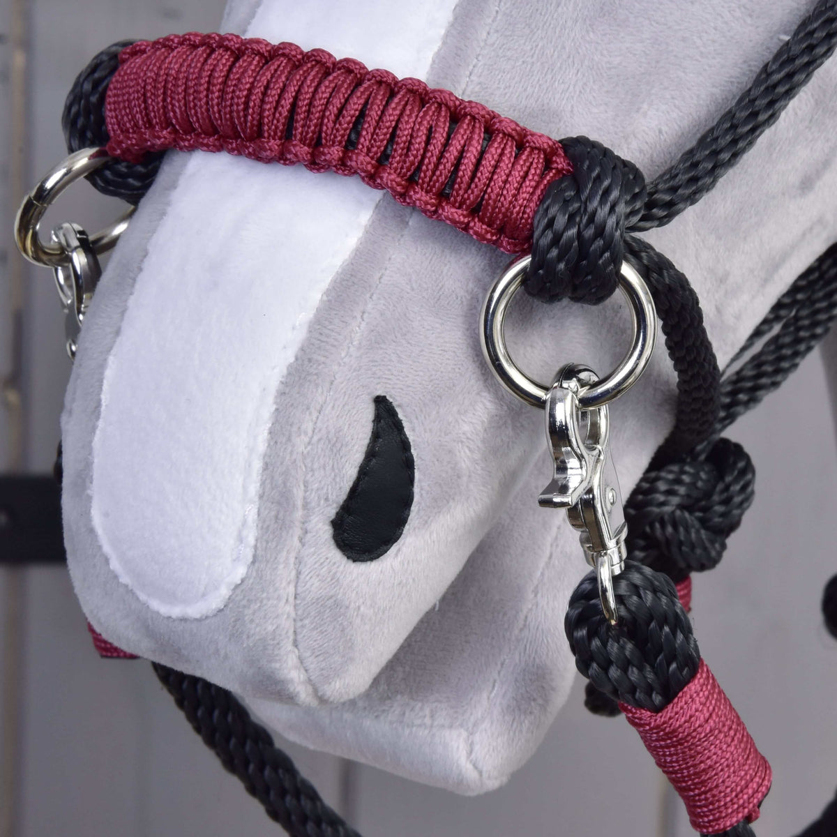 Närbild på den rödbruna flätade nosremmen på Hobby Horse repset Maroon med svart rep, silverfärgad ring och karbinhake