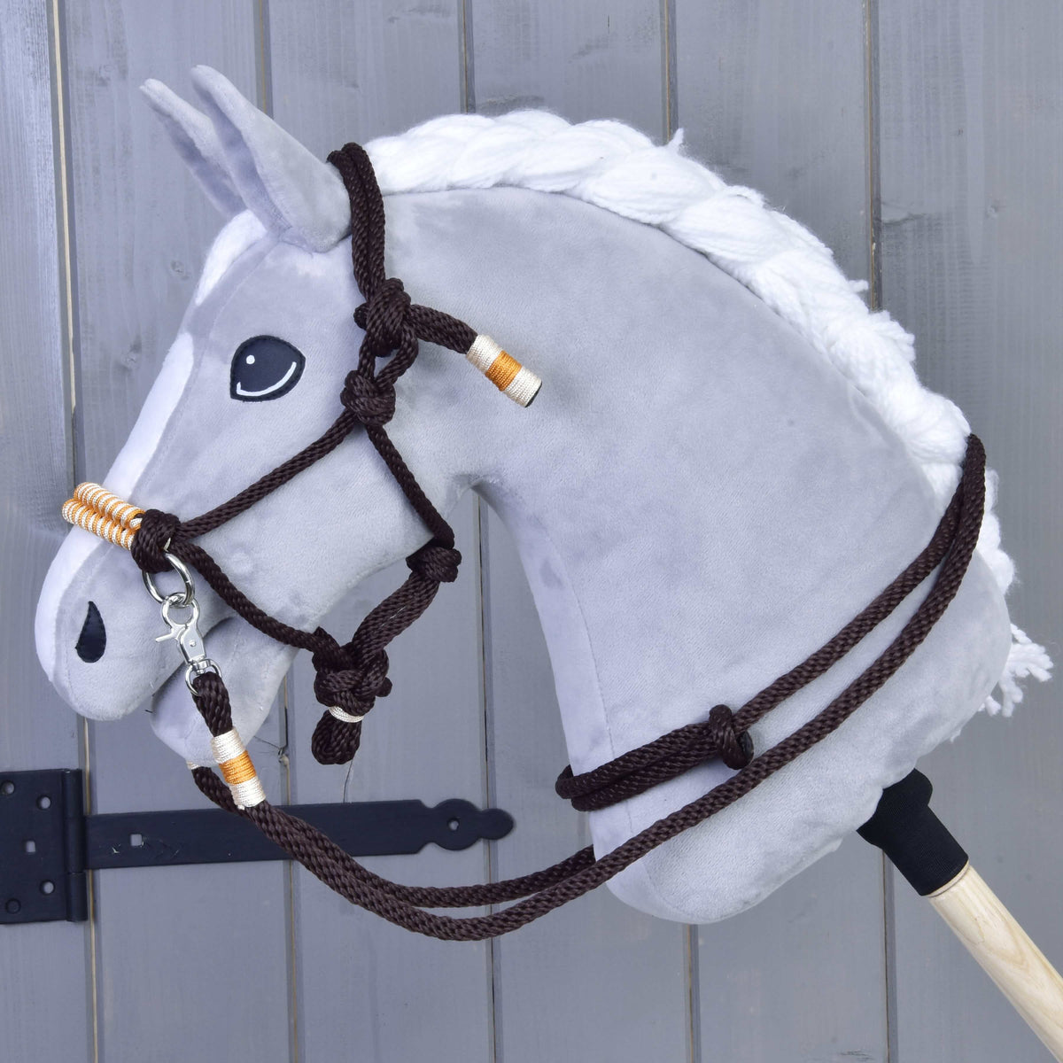 Grey Hobby Horse with a white braided mane wearing the Rope set Orange, a dark brown rope halter and reins with orange wraps