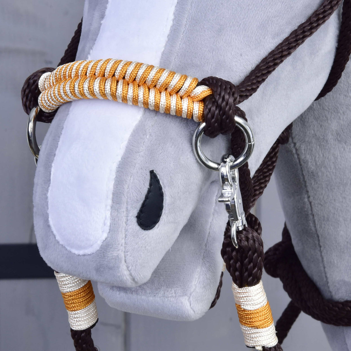 Close-up of the Hobby Horse Rope set Orange noseband, braided in orange and white, with a silver ring and snap hook