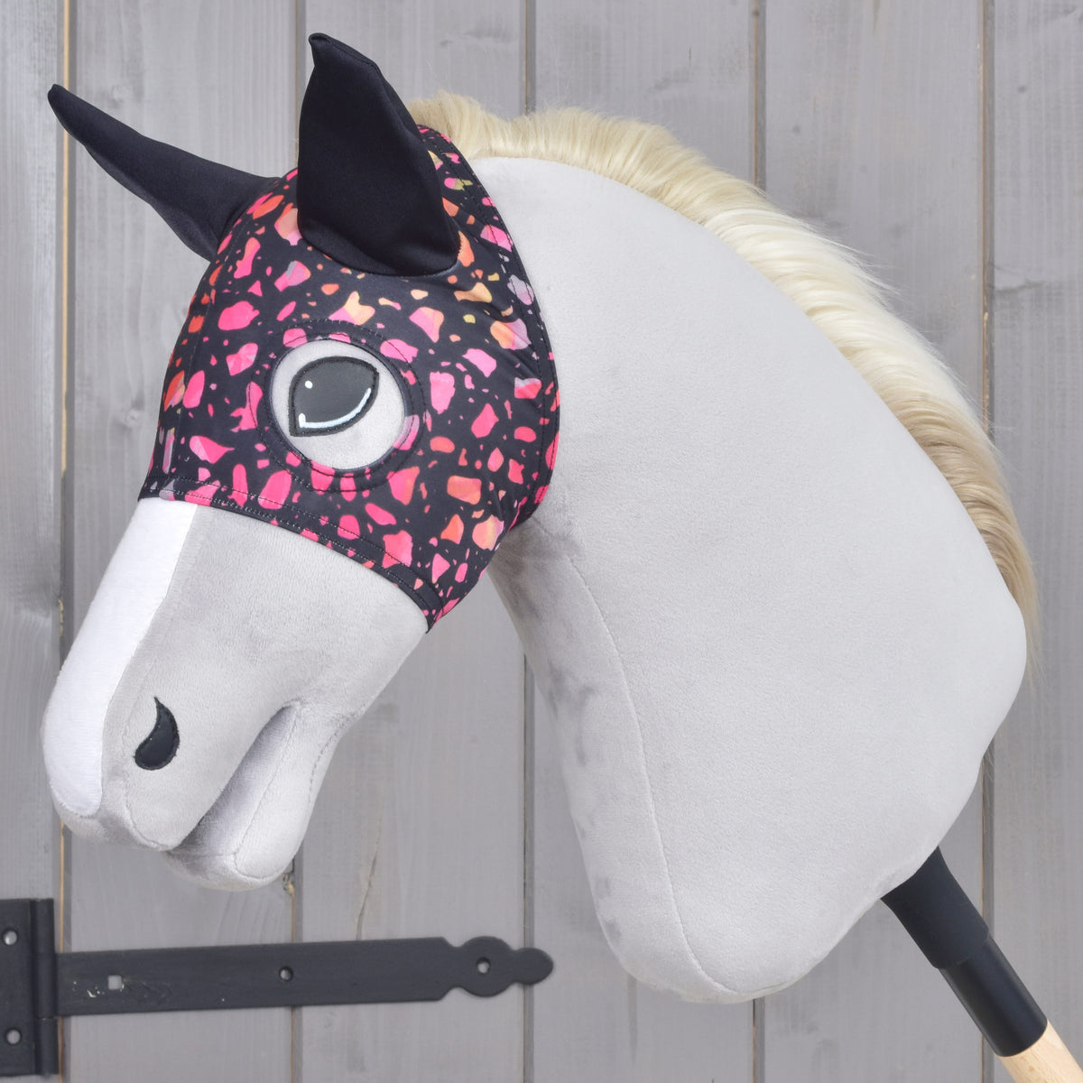 Horse Mask Roxy by LarDen on a light grey Hobby Horse, black with pink, coral and peach terrazzo flecks and black ears