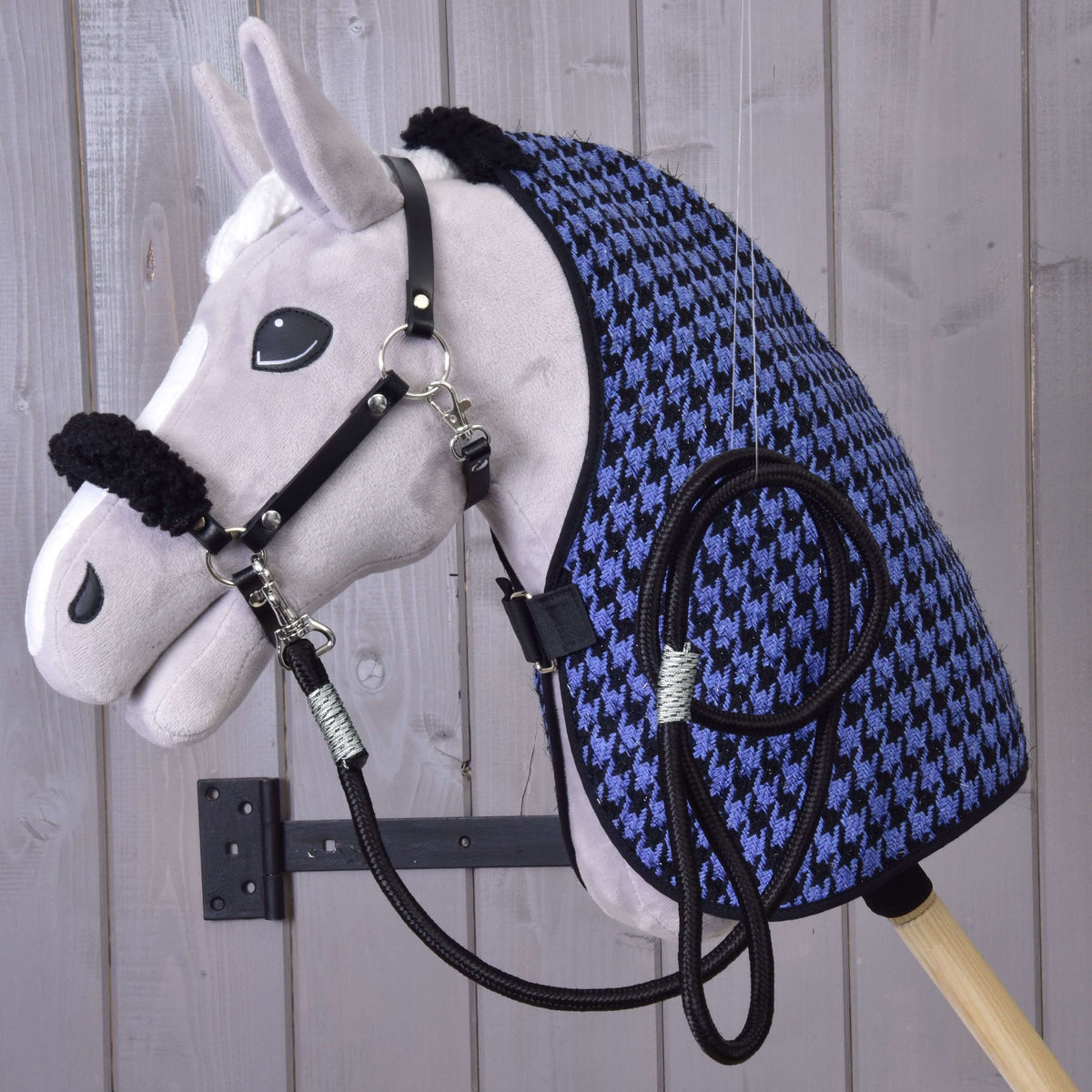 Grey plush Hobby Horse wearing the houndstooth blanket, black halter with fur and black lead rope of Set Harmony Blue