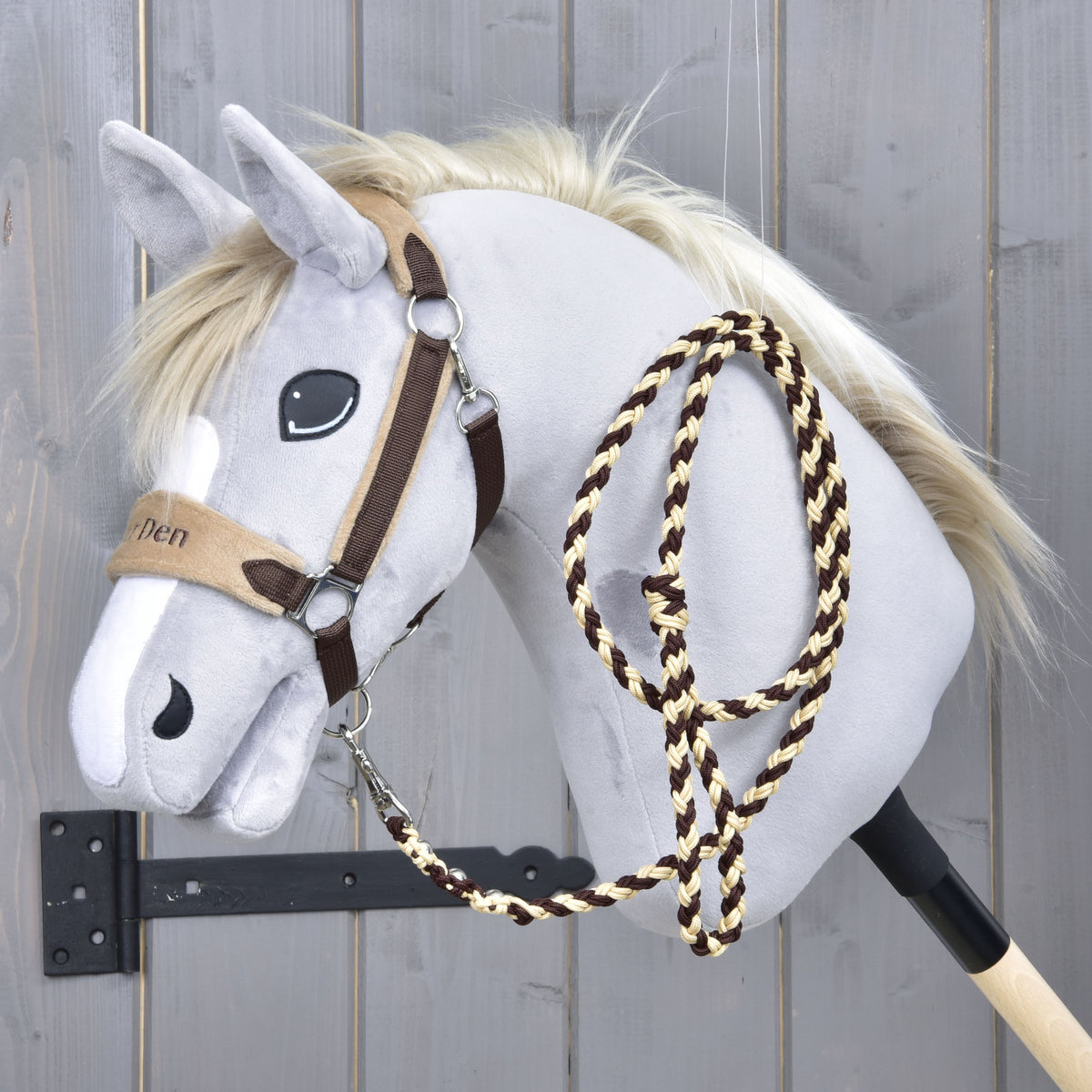 Grey Hobby Horse in the Exclusive Braun halter with embroidered beige noseband, the brown and cream lead rope over its neck