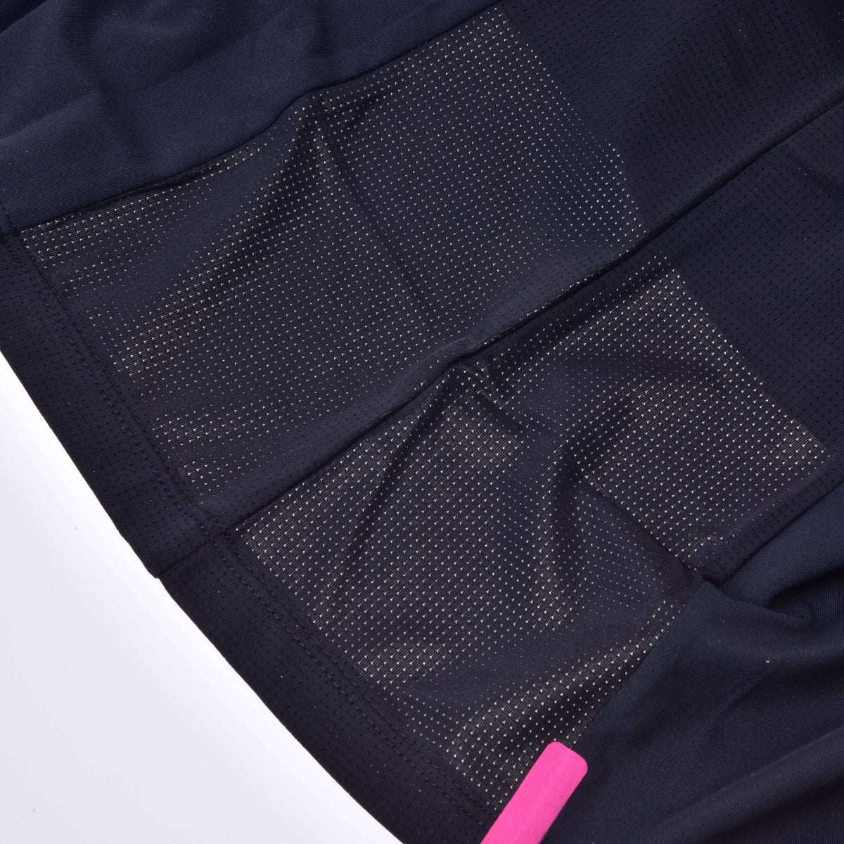 Close-up of the black mesh side panels and a pink tab at the hem of the Hobby Horse T-Shirt Active