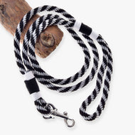 LarDen Hobby Horse Lead rope stripe black, a black and silver twisted lead with white whipping and snap hook on a branch